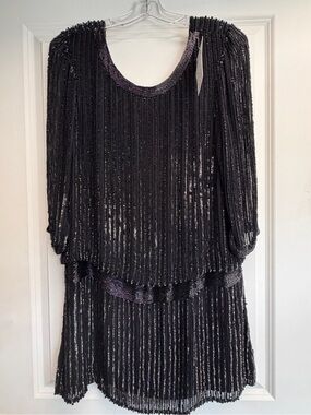 Parker women's long sleeve mini sequin dress features a classic scoop neck.